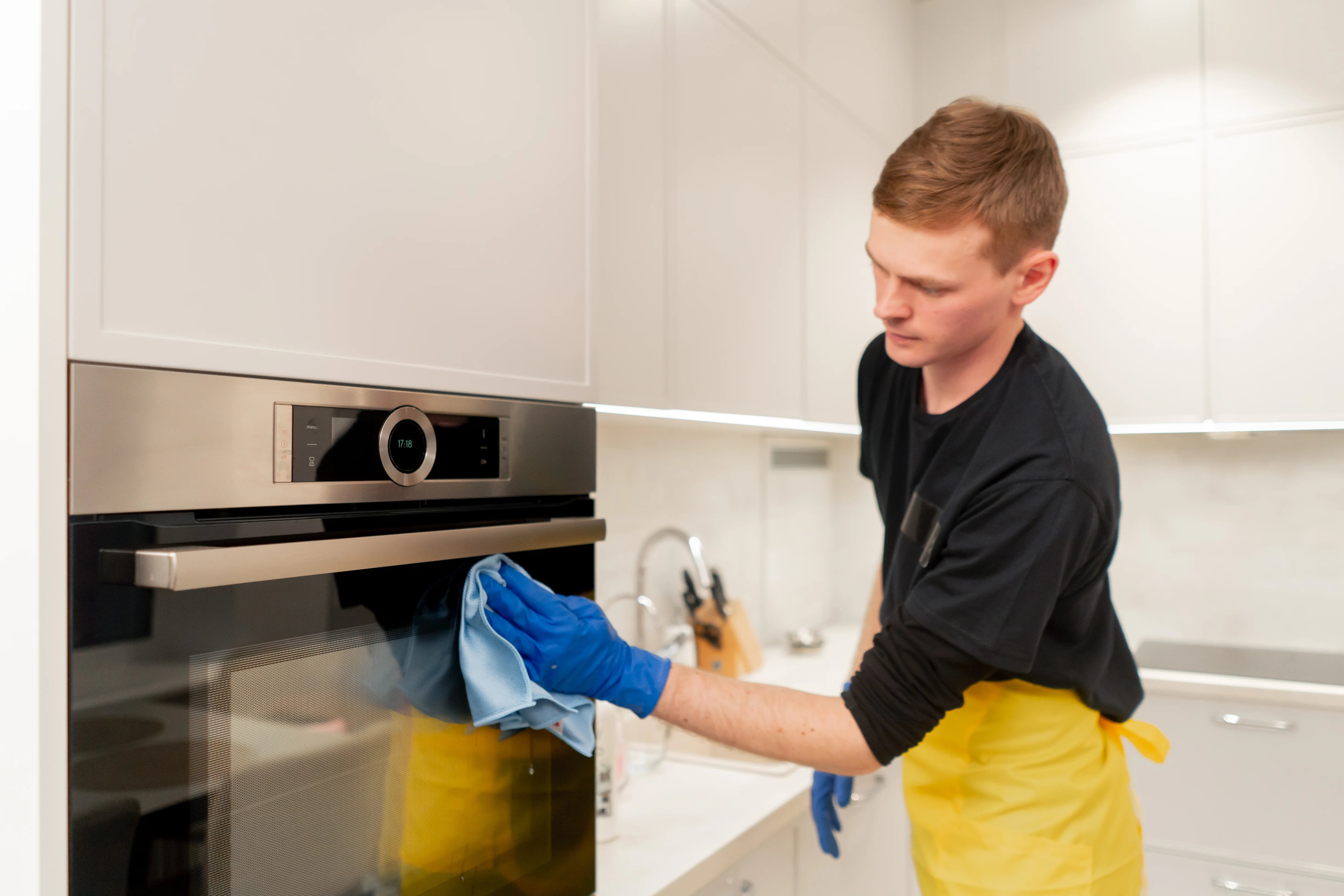 Cleaning kitchen cabinets and appliances during post construction cleaning